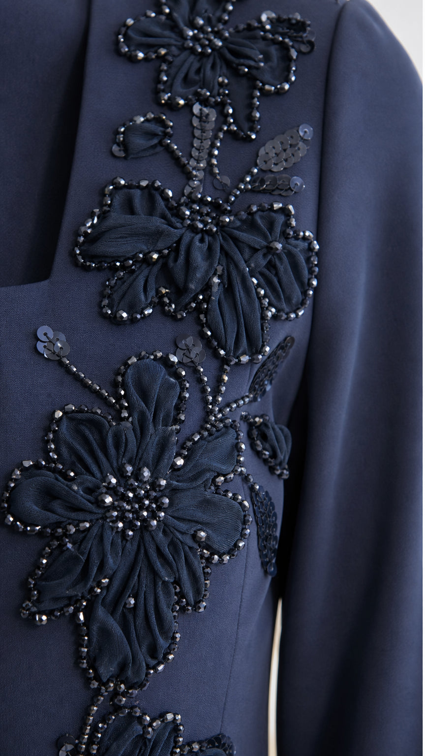 Close-up detail of floral embroidery and beadwork on the bodice