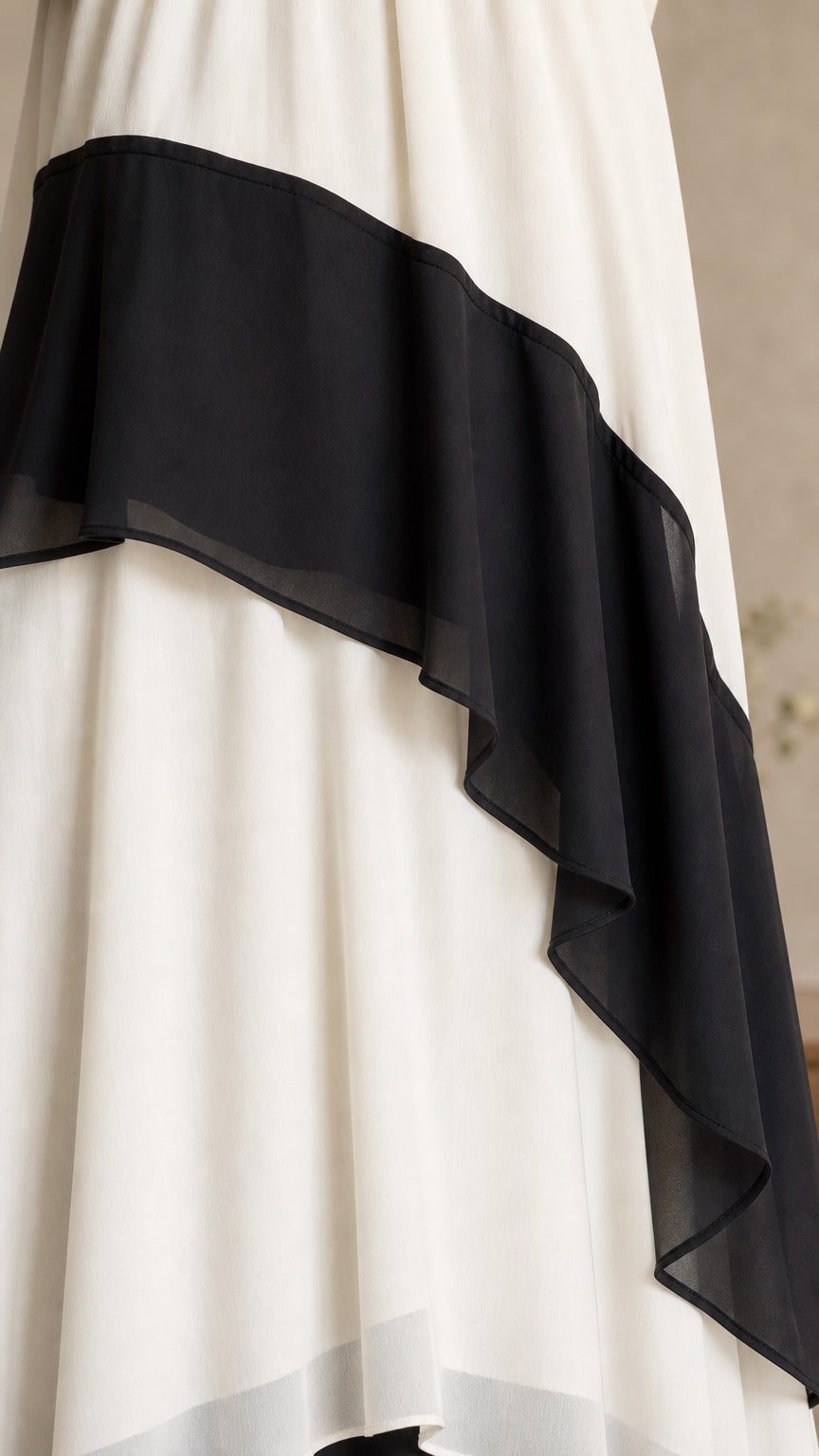 Close-up detail of layered black and white ruffle hem