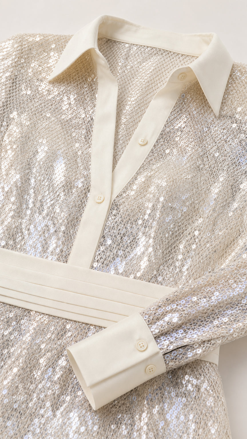 Close-up detail of shirt collar, buttons, and sequin texture