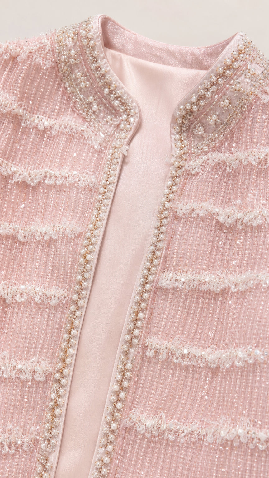 Close-up of pink tweed jacket detailing and beadwork
