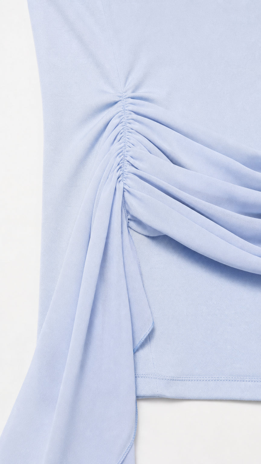 Close-up detail of hip ruching and fabric sash