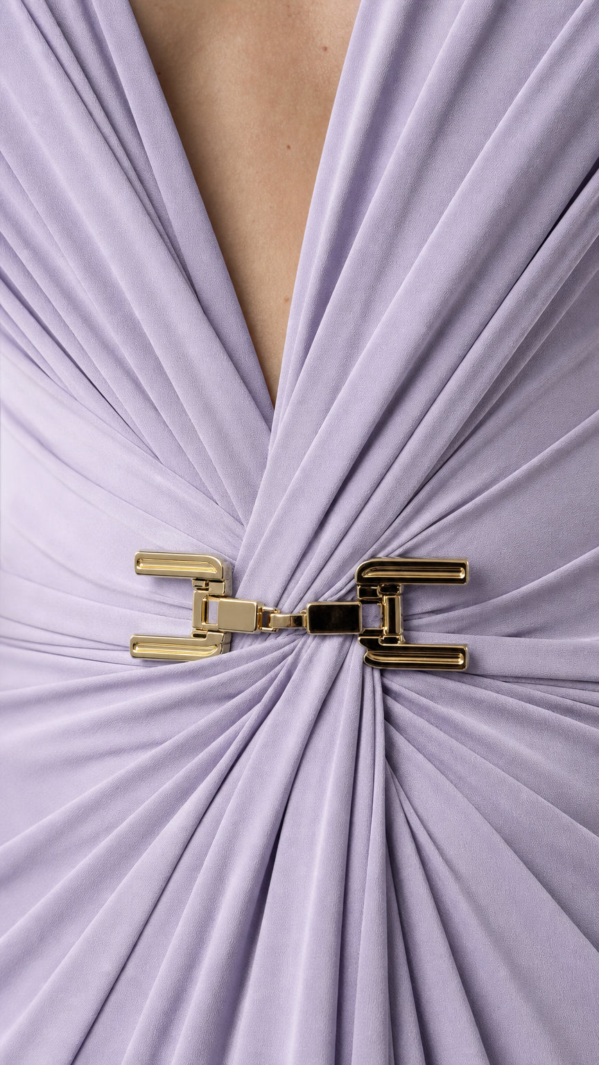 Close-up of plunging V-neckline and gold hardware detail