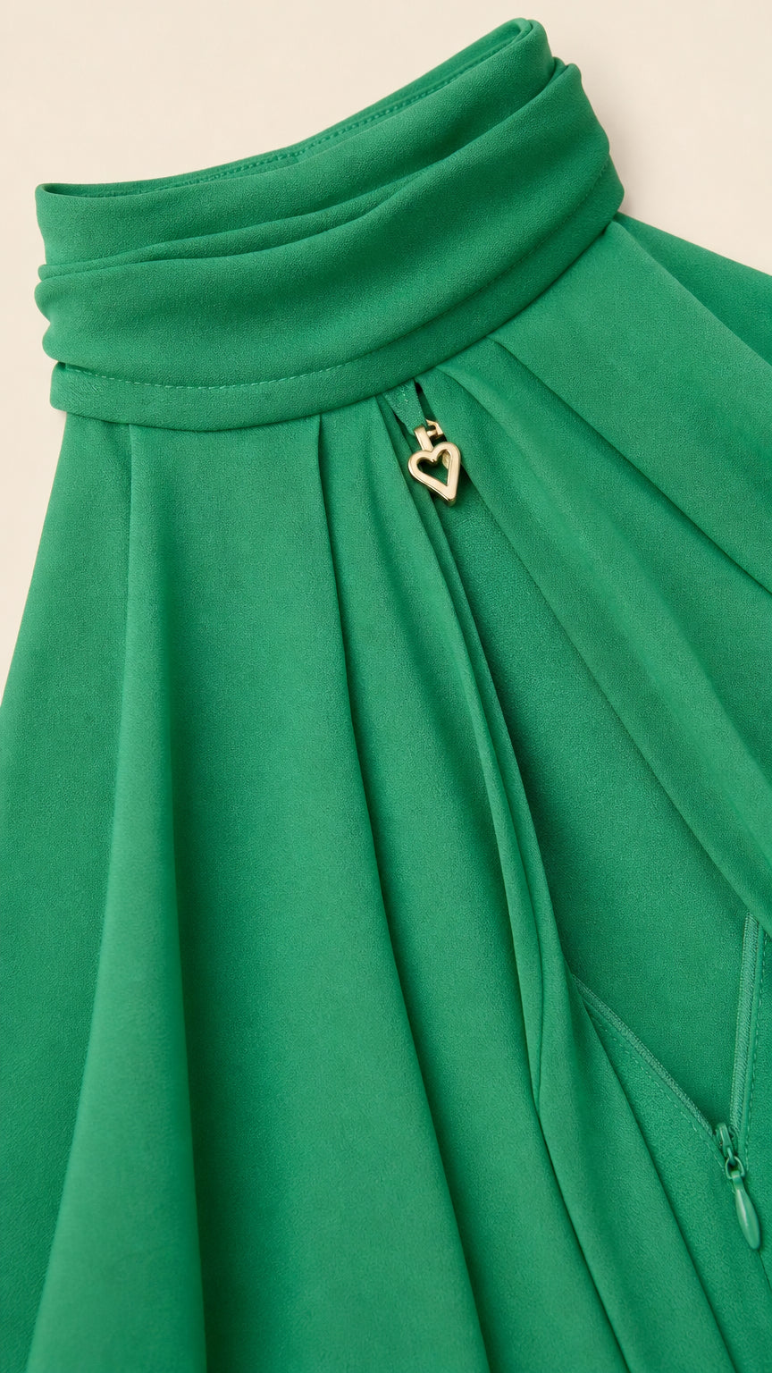Close up of neckline detail with gold heart charm on green dress