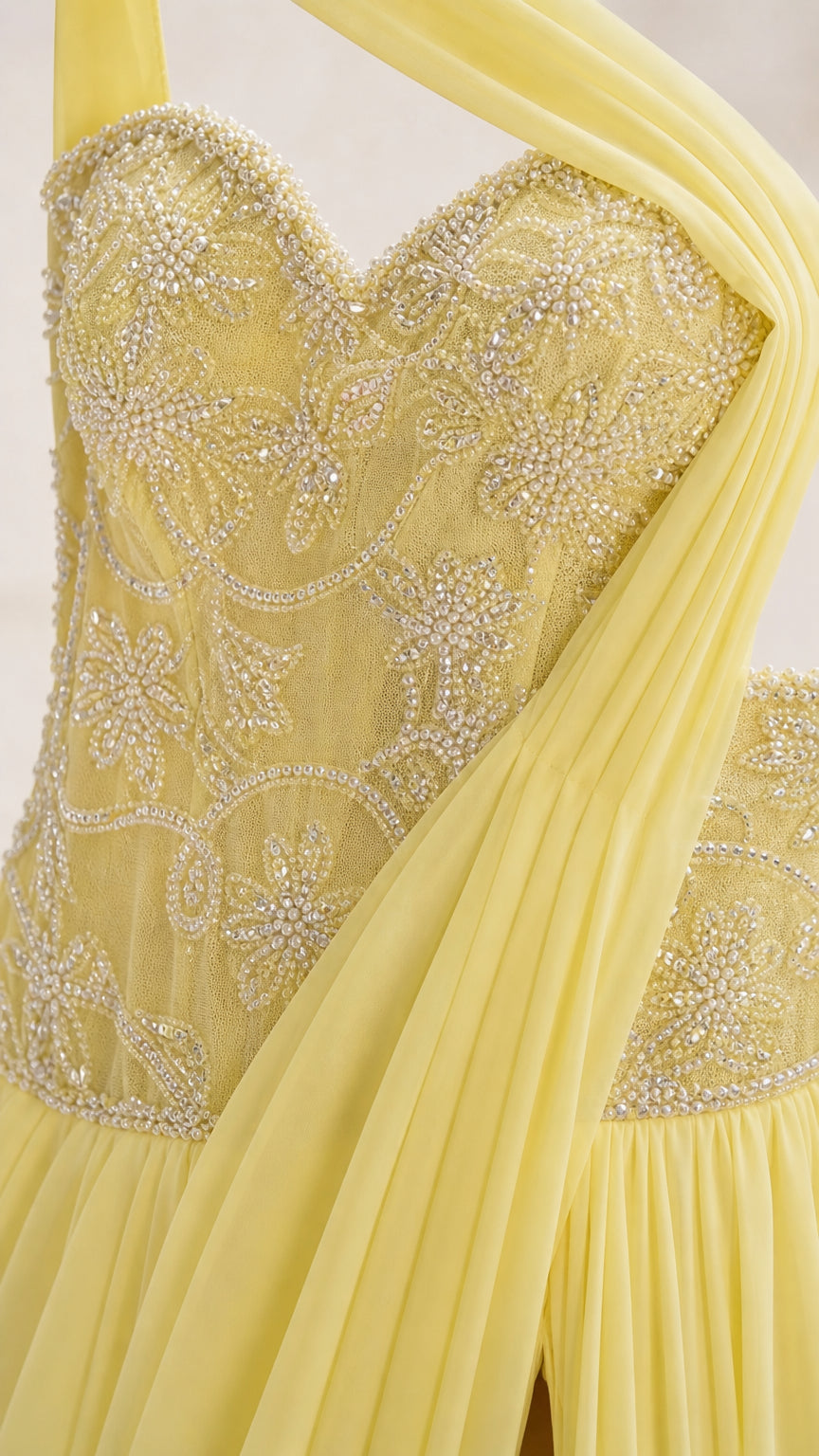 Close-up of the embellished beaded bodice and draped shoulder