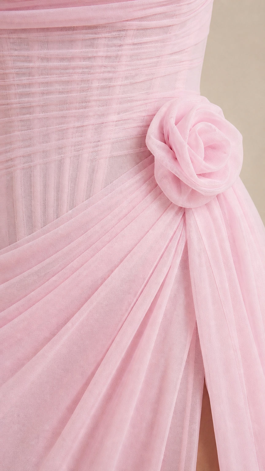 Close-up detail of the 3D rosette and ruched bodice on the pink gown