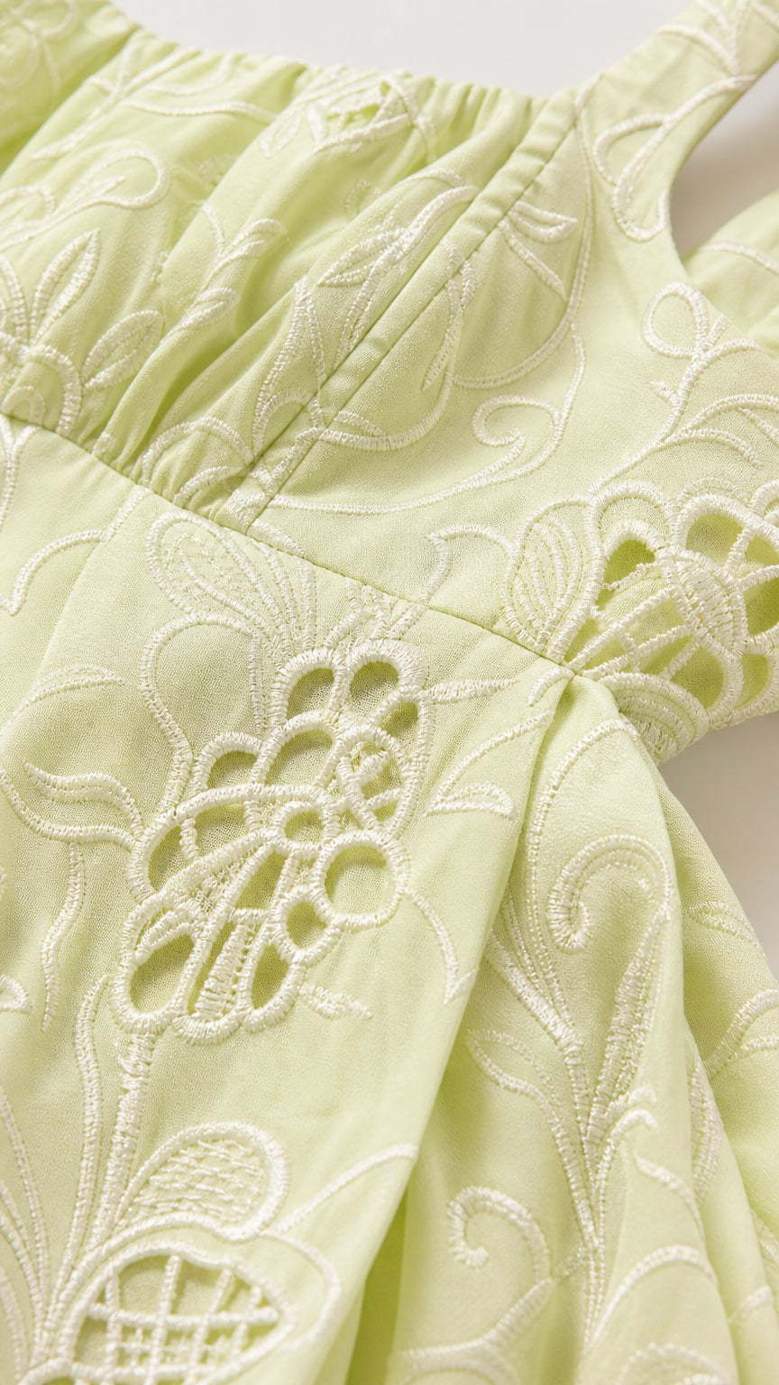 Close-up detail of tonal floral embroidery and eyelet cutwork on Light Green fabric