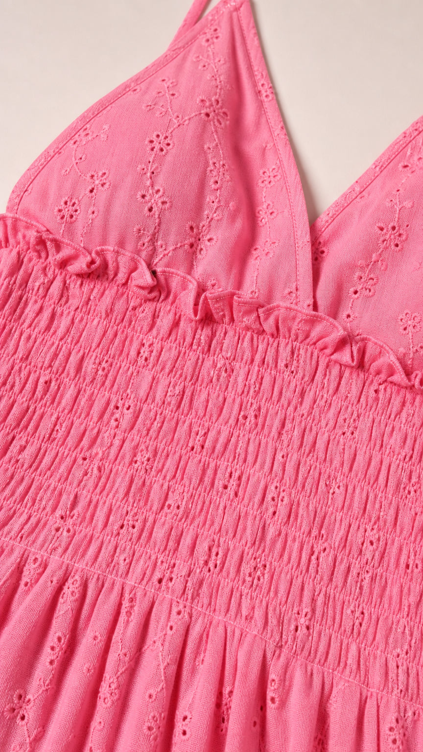 Close-up of pink dress textured fabric and smocked bodice detail