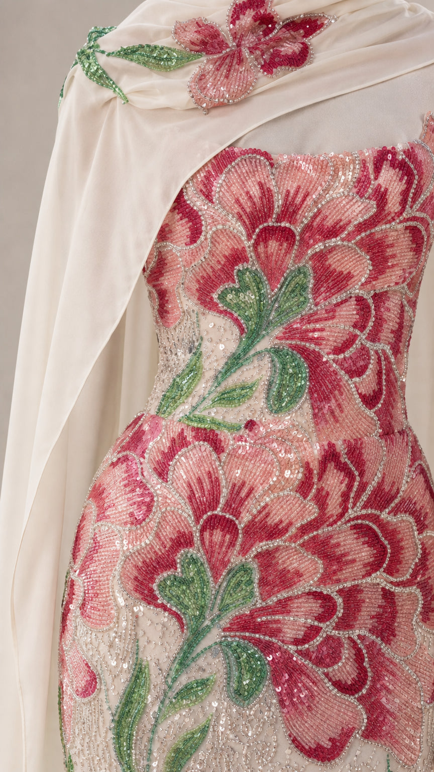 Close-up detail of red and green floral beadwork and embroidery