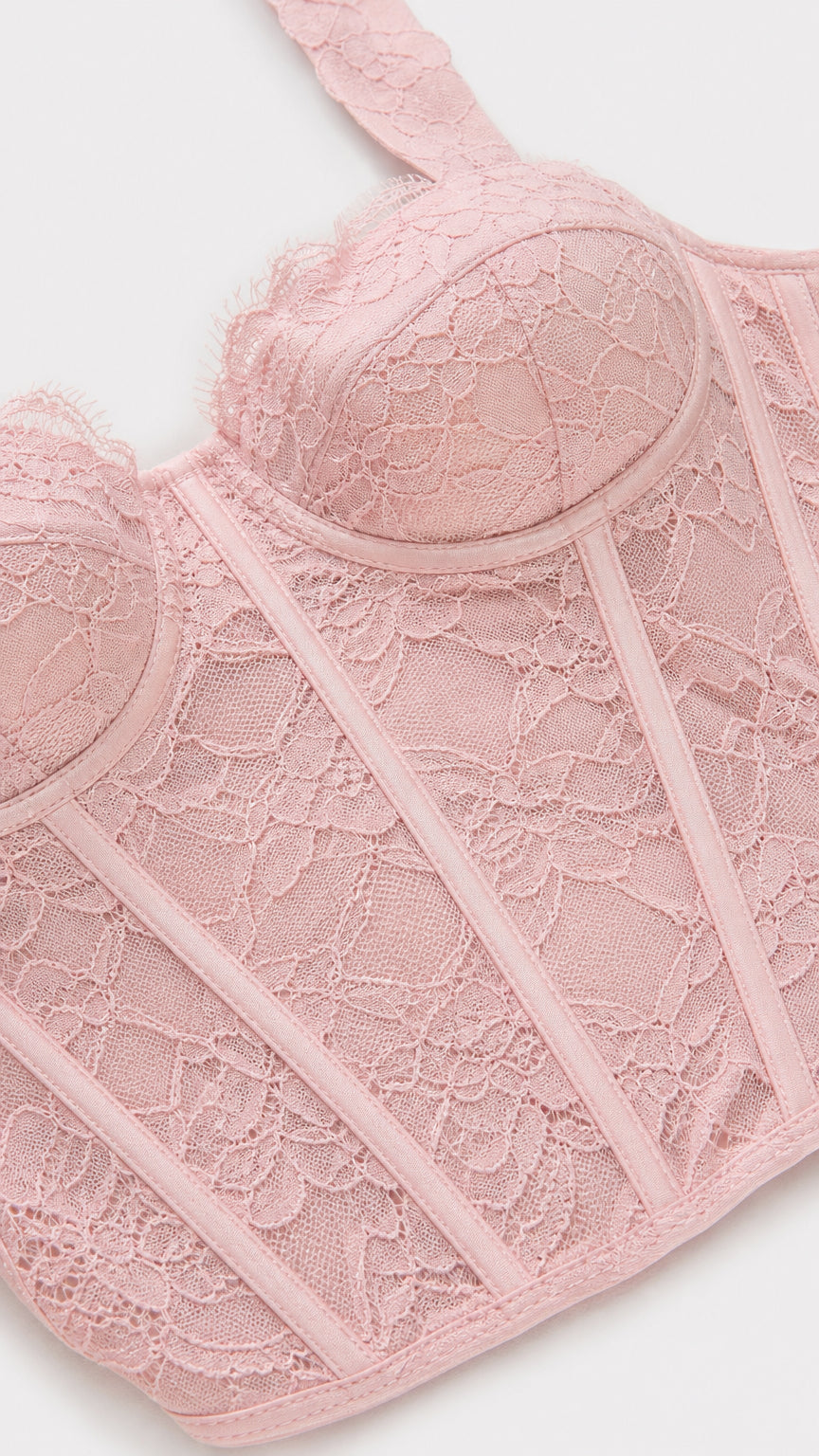 Close-up detail of pink lace corset top construction