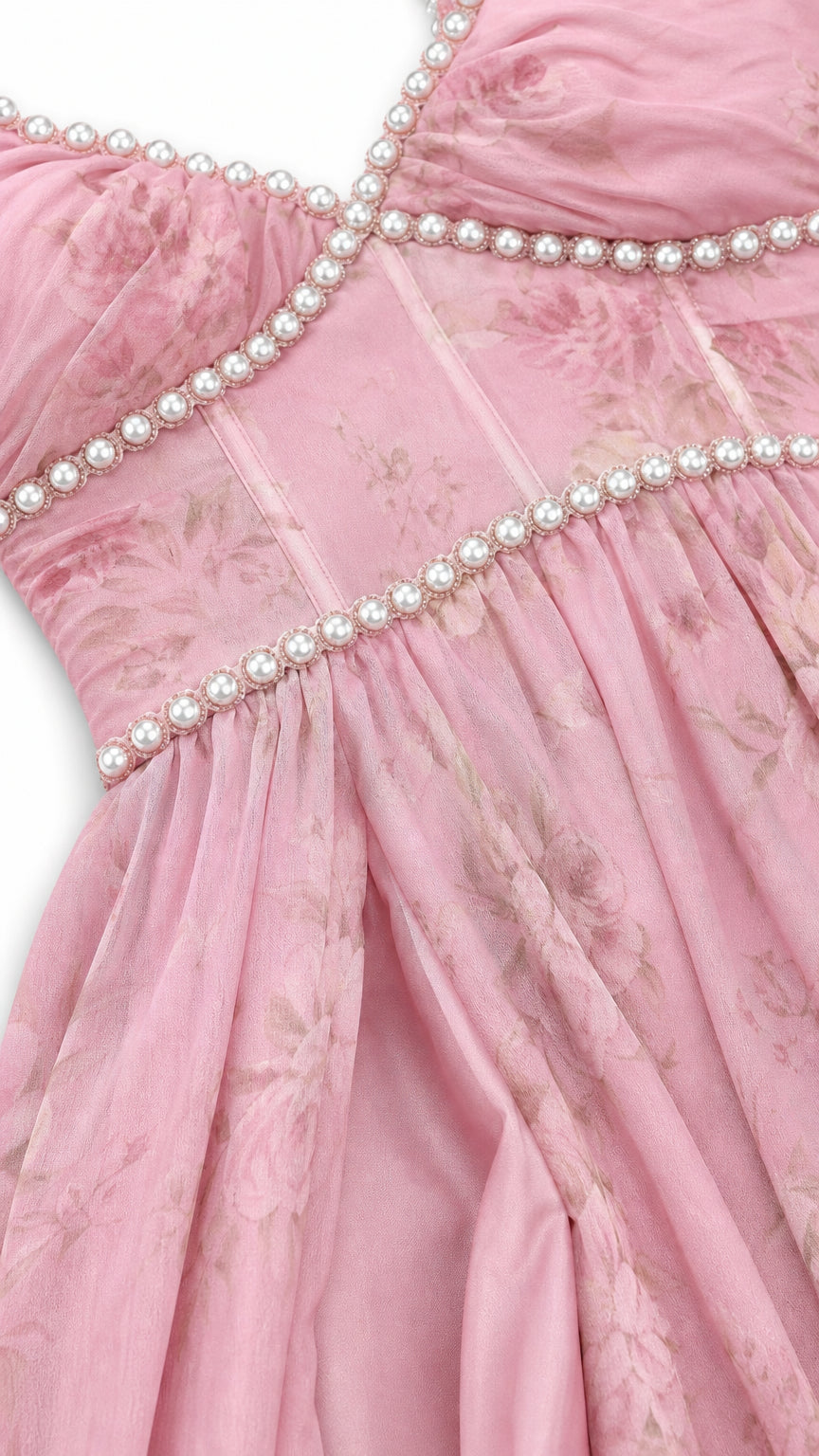 Close-up detail of faux pearl beading on bodice and neckline of pink dress