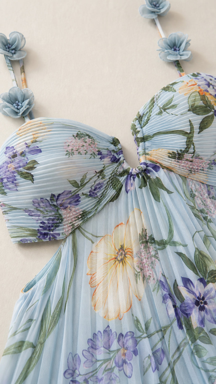 Close-up detail of pleated bust and 3D floral strap embellishments