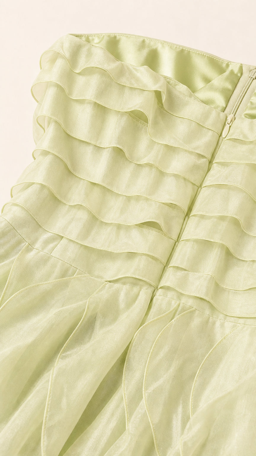 Close-up of sage green fabric texture and ruffles