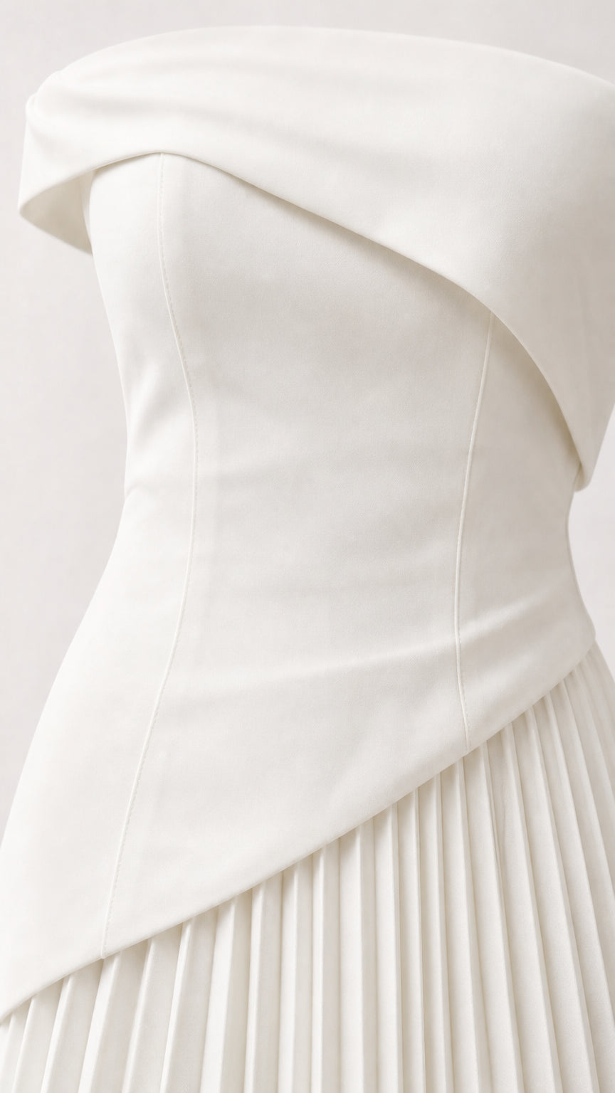 Close-up detail of white structured asymmetric bodice