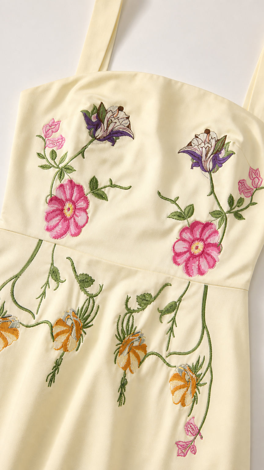 Close-up detail of floral embroidery and square neckline