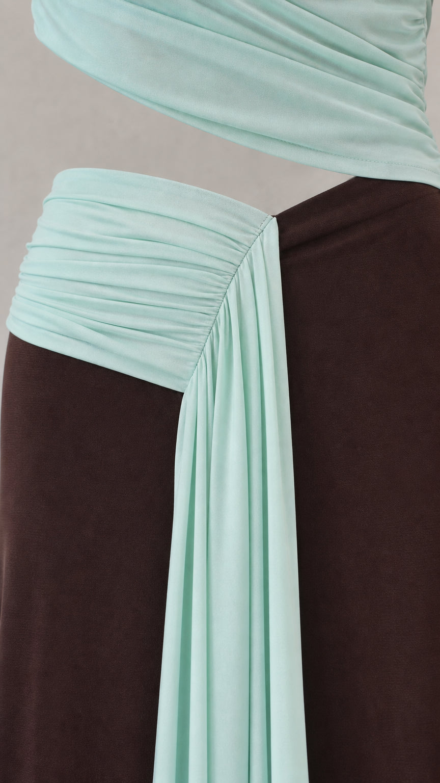 Close-up detail of diagonal ruching and draped skirt fabric