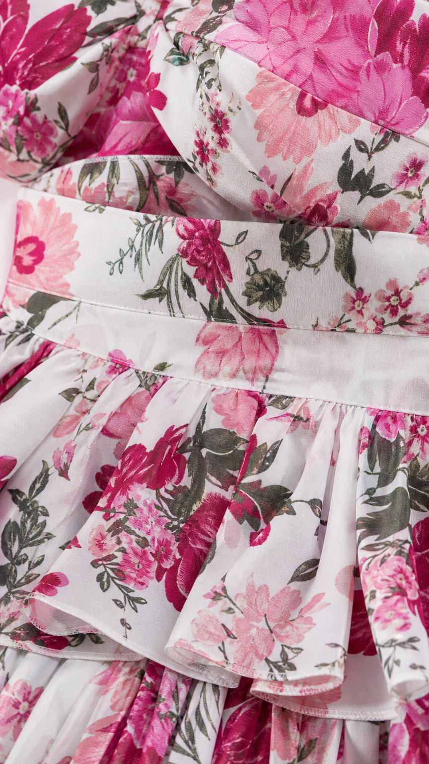 Close-up detail of the floral print fabric and ruffle tiers