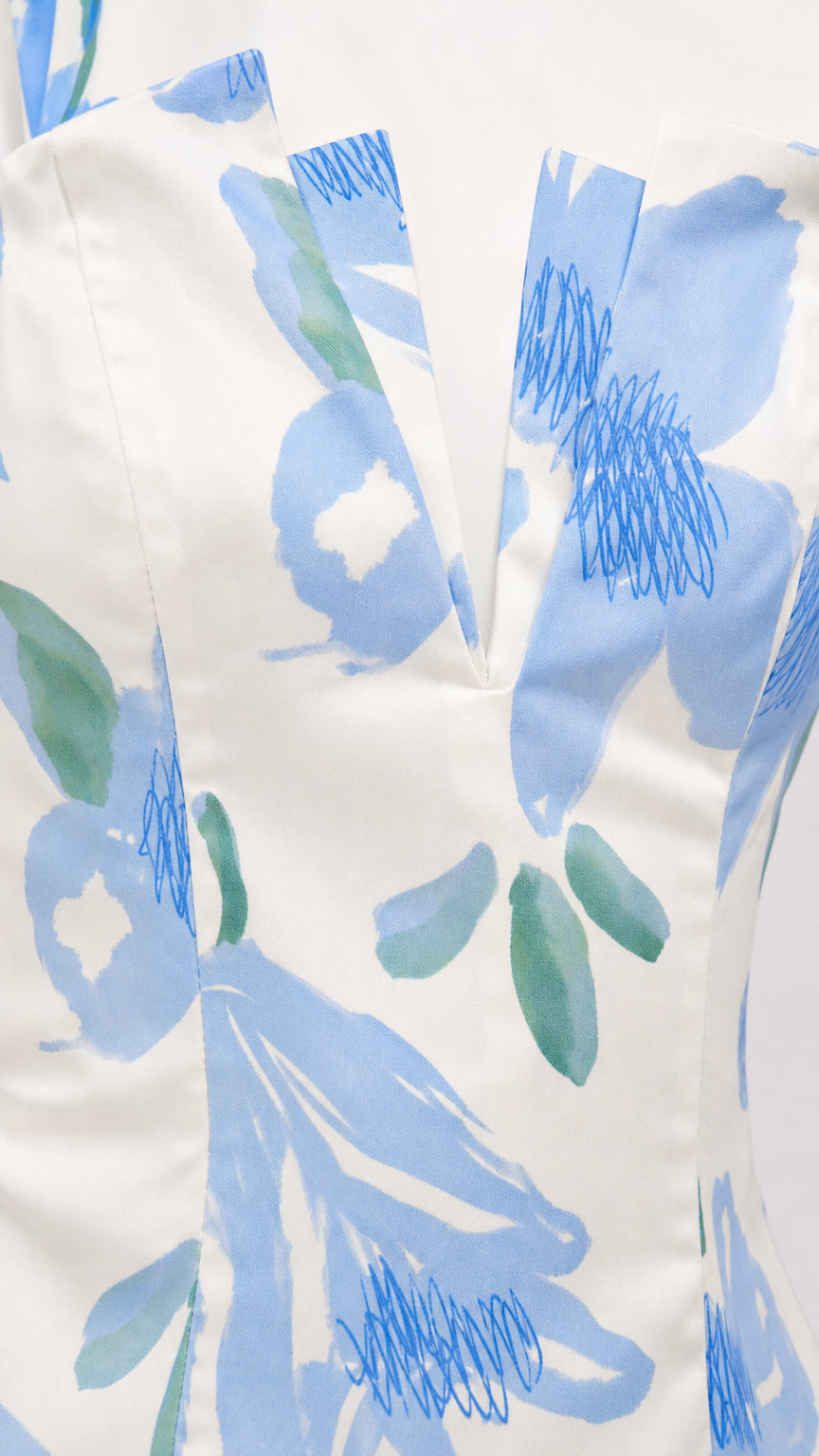 Close-up detail of the V-notch neckline and floral fabric