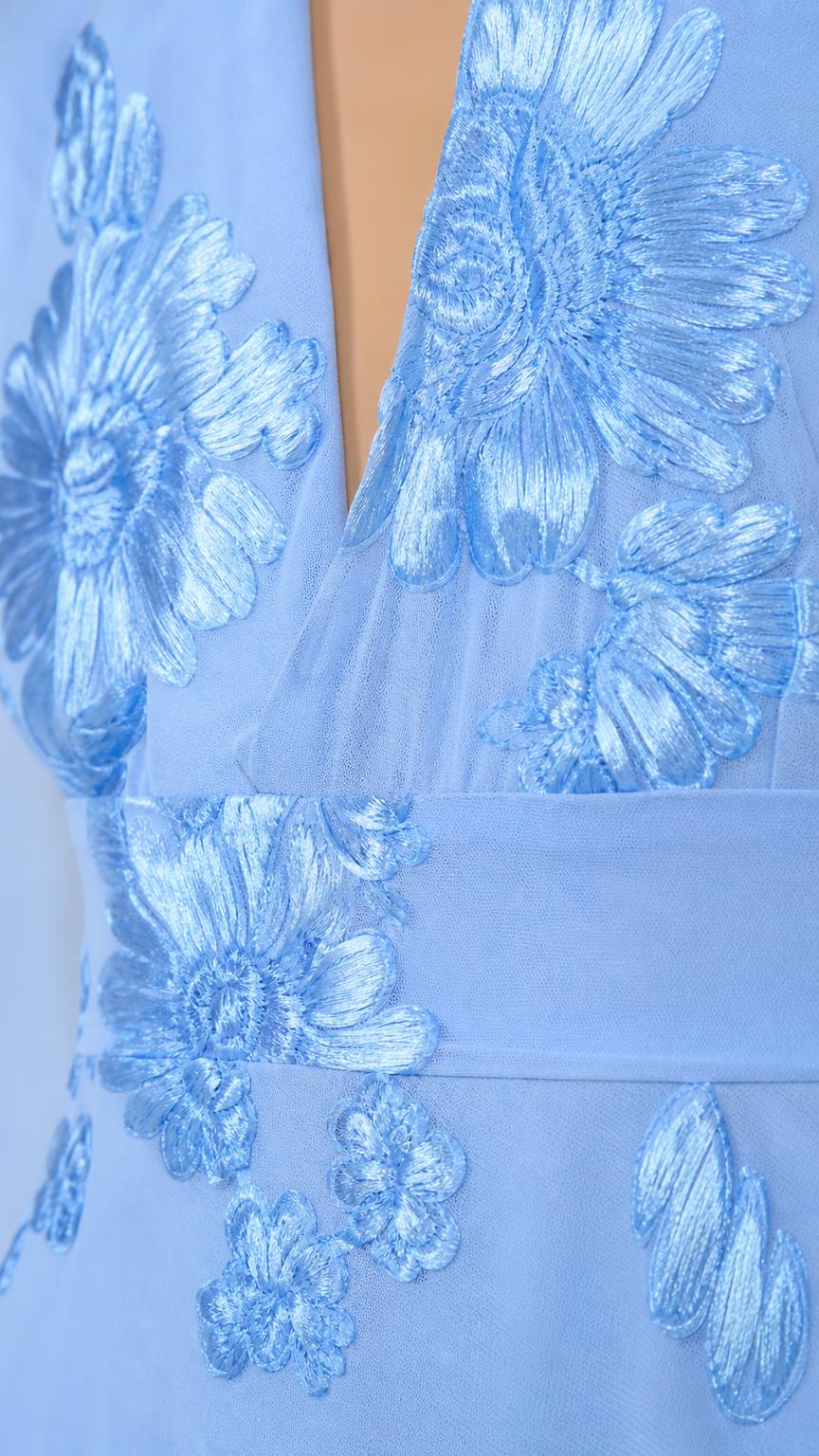 Close up detail of blue floral appliques and plunge neckline