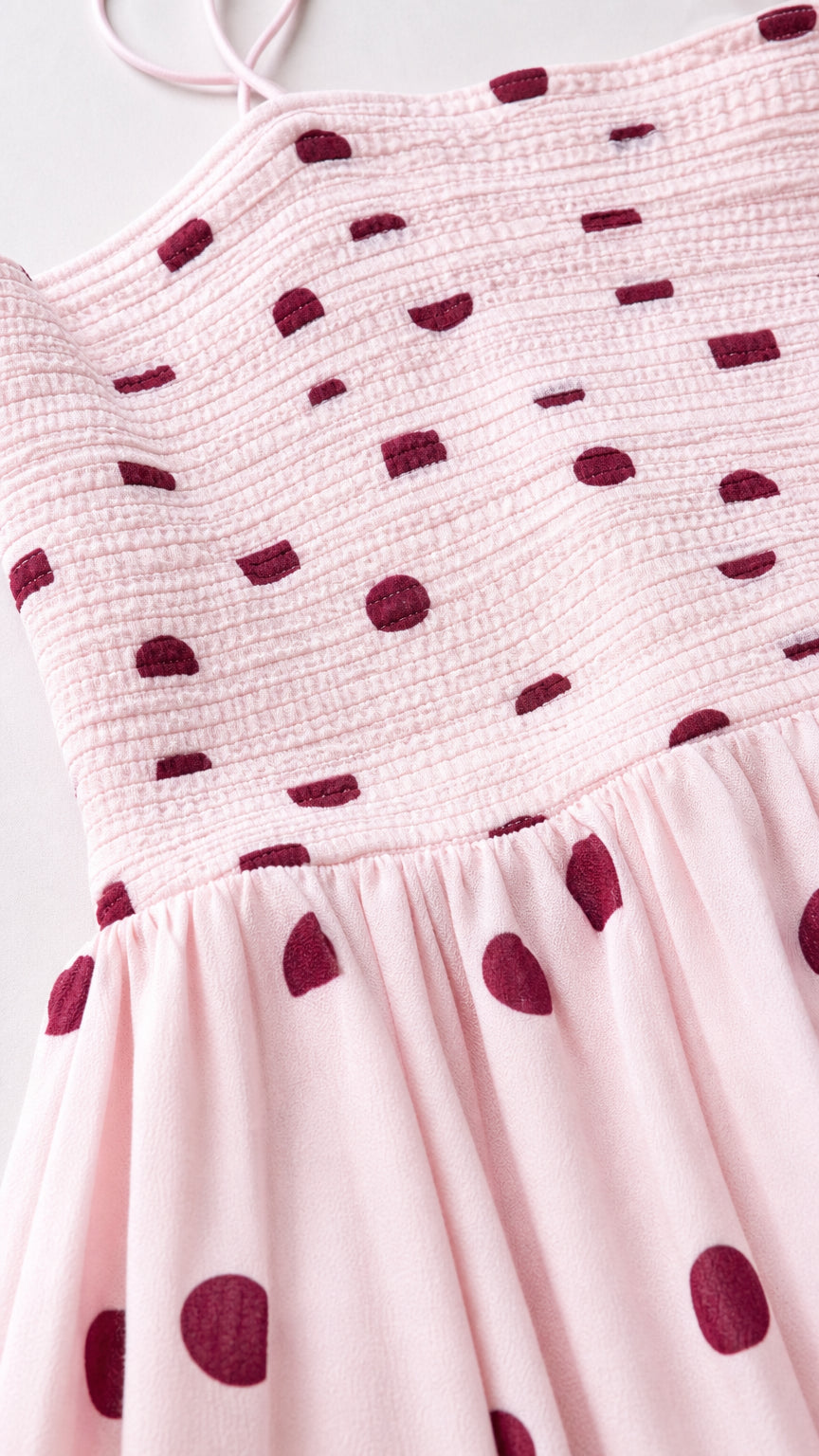 Close-up detail of smocked bodice and polka dot pattern