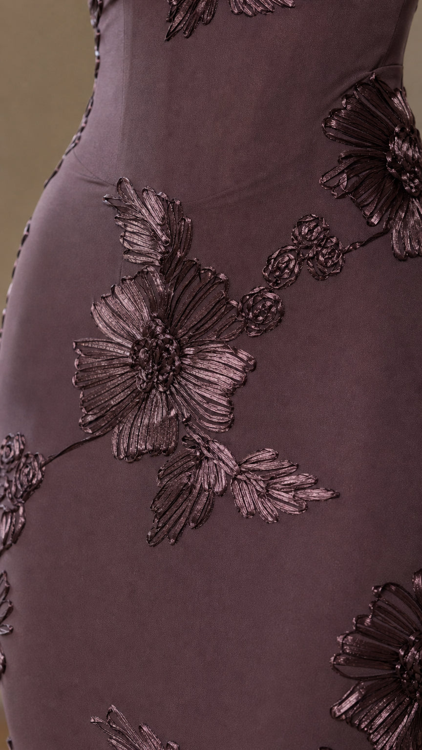 Close-up of dimensional floral embroidery on burgundy dress