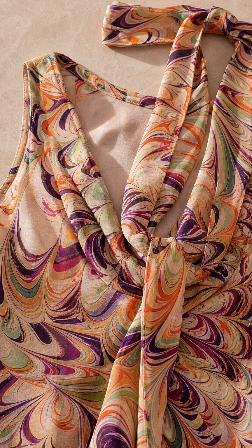 Close-up detail of halter neckline and smooth fabric texture