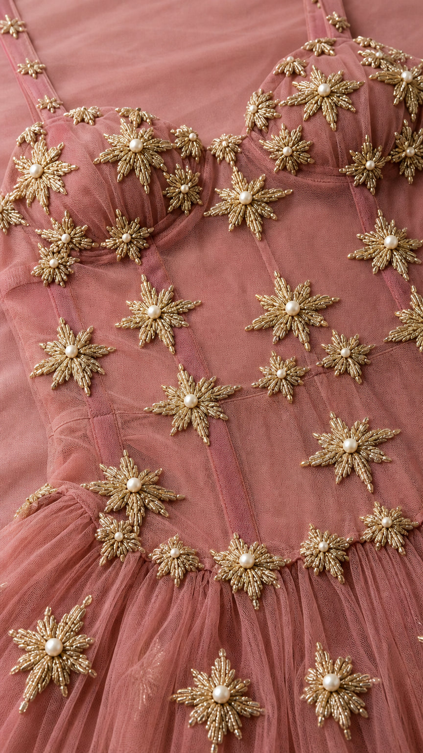 Close-up detail of bodice embroidery and beaded star motifs