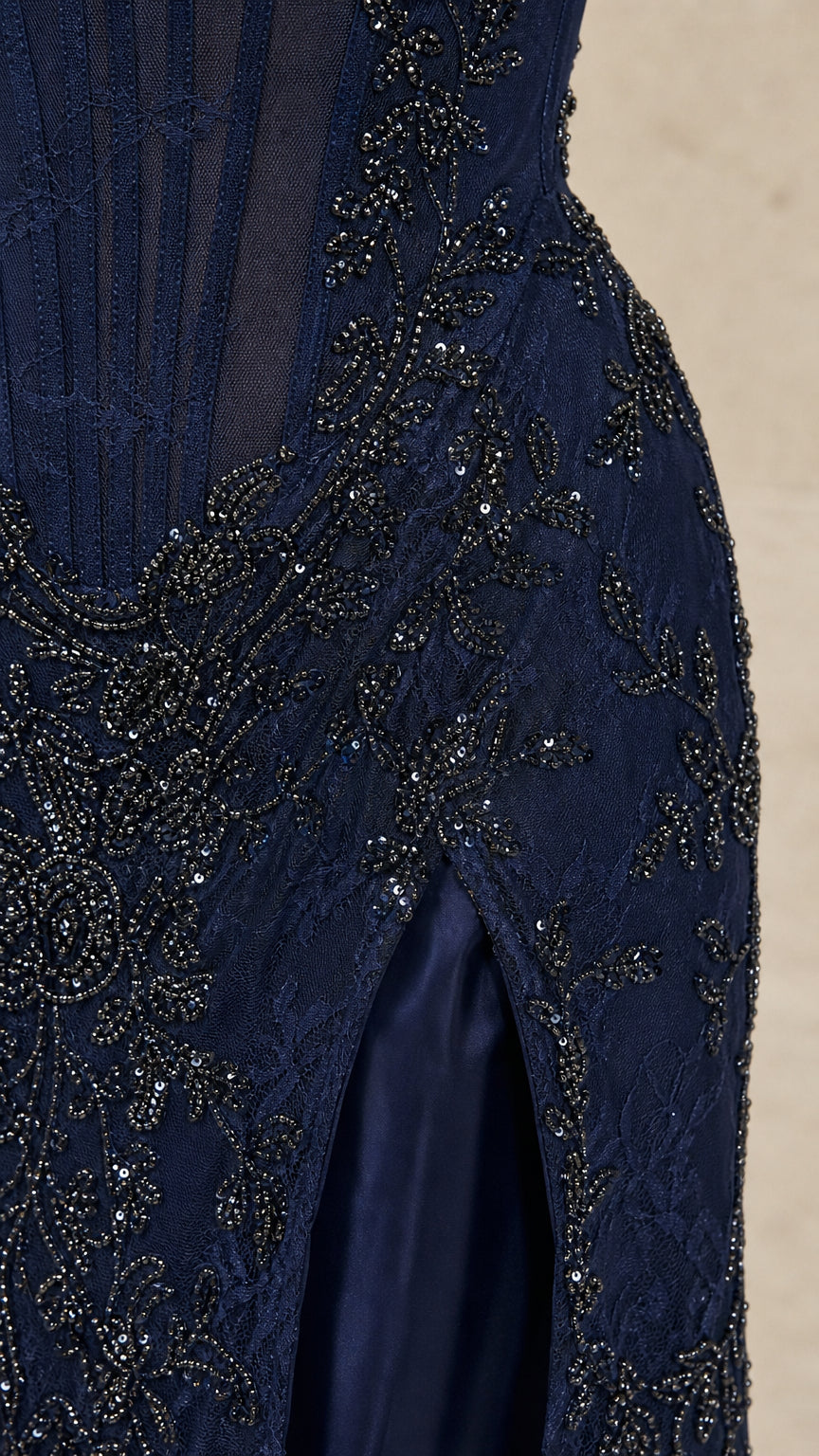 Close-up of intricate beadwork and high slit on Navy dress