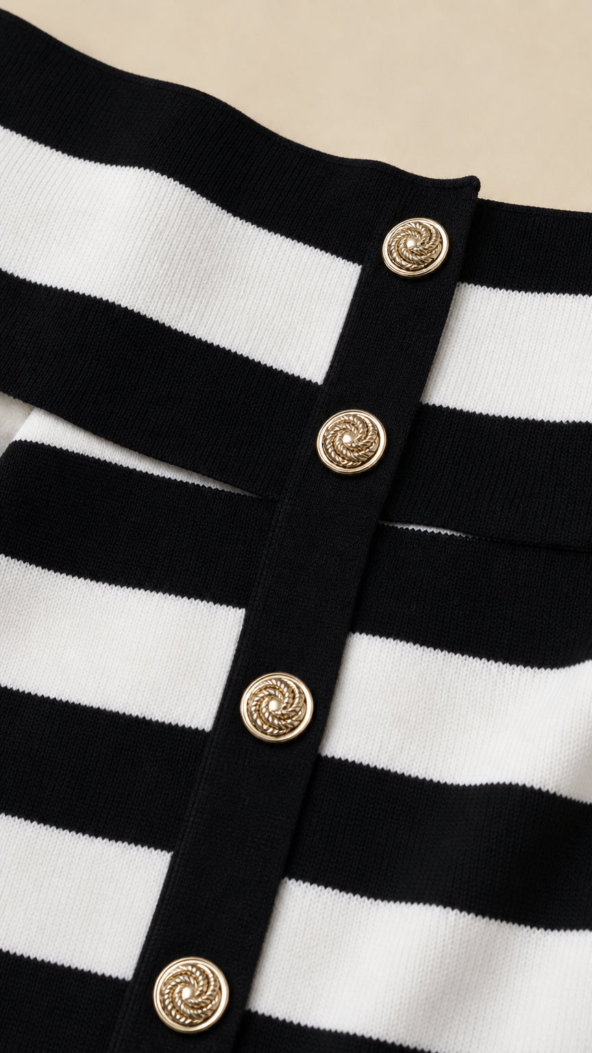 Close-up detail of gold-tone buttons on the striped knit dress