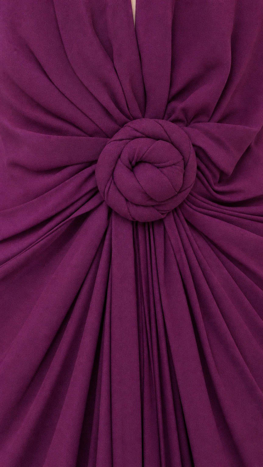 Close-up of fabric texture and rosette waist detail in purple
