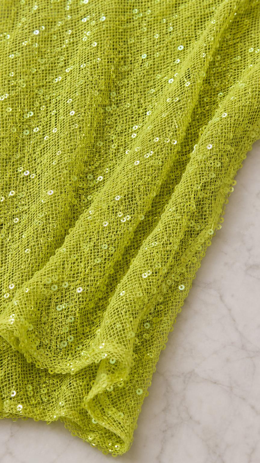Close-up texture of lime sequin mesh fabric