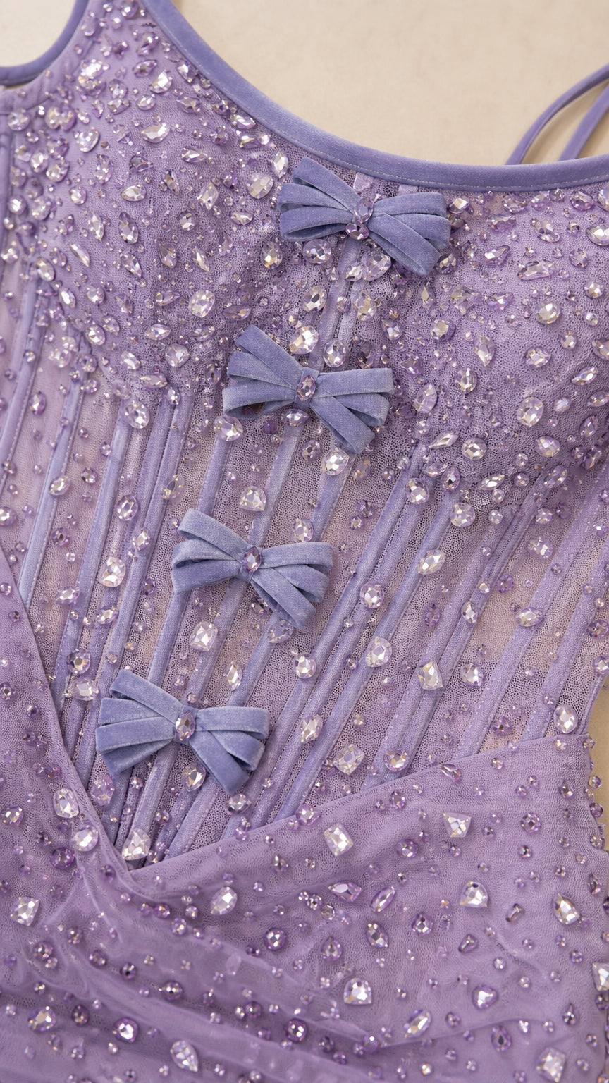Close-up of bodice details showing rhinestones and bows on lavender dress