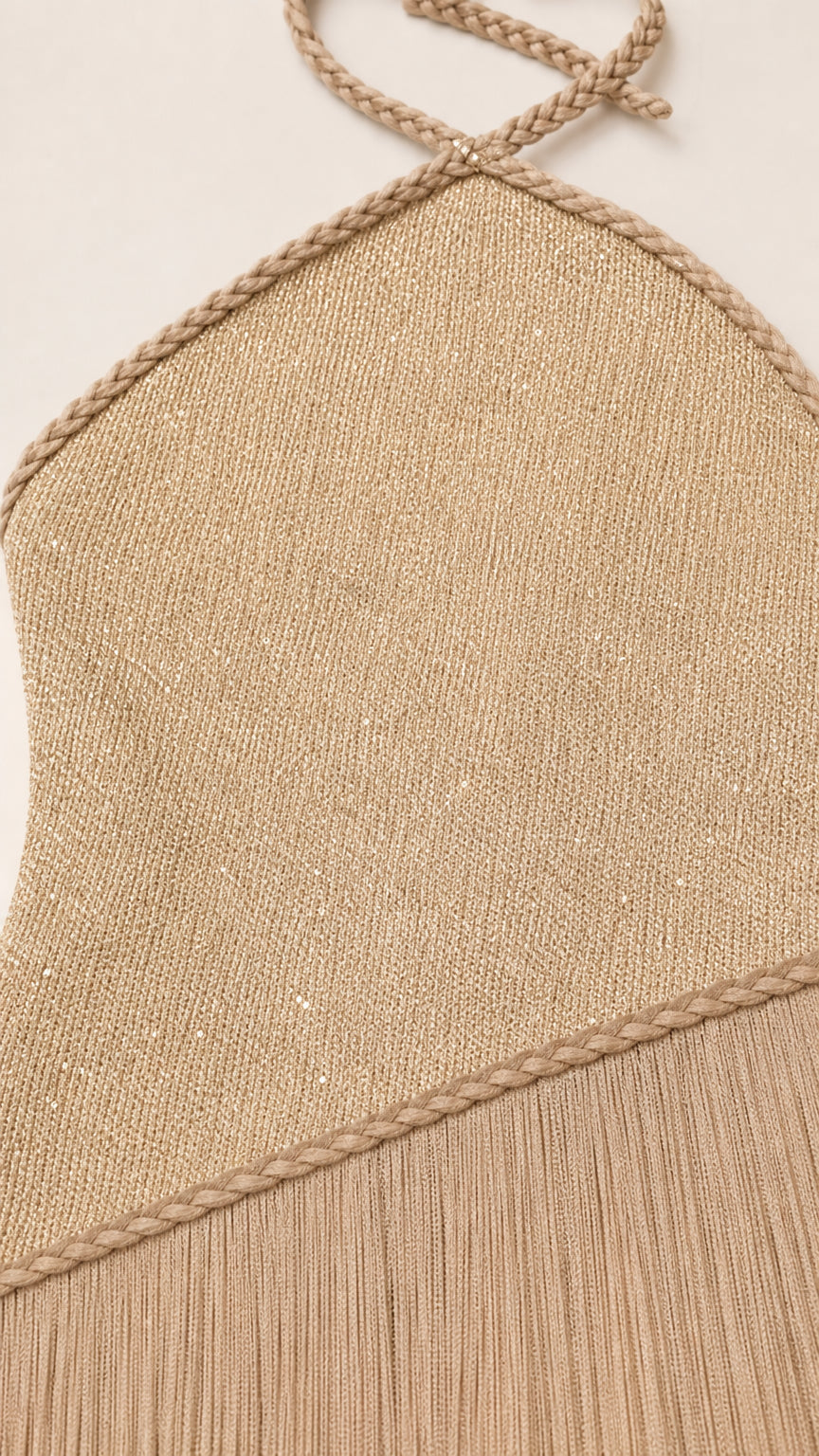 Close-up detail of halter neck strap and metallic knit texture