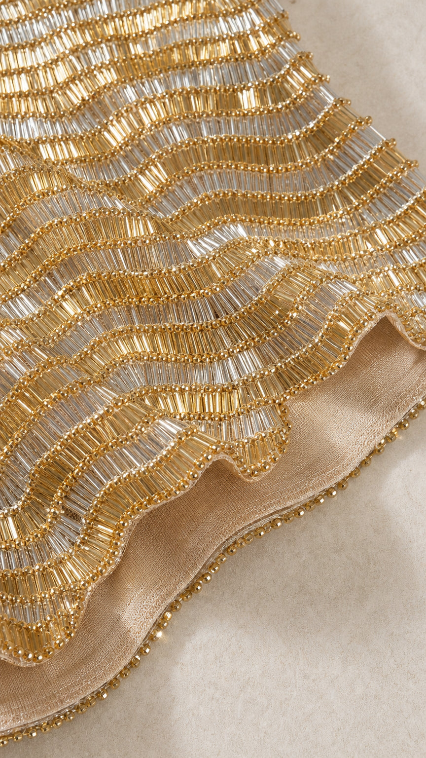Close-up detail of gold and silver sequin wave beadwork