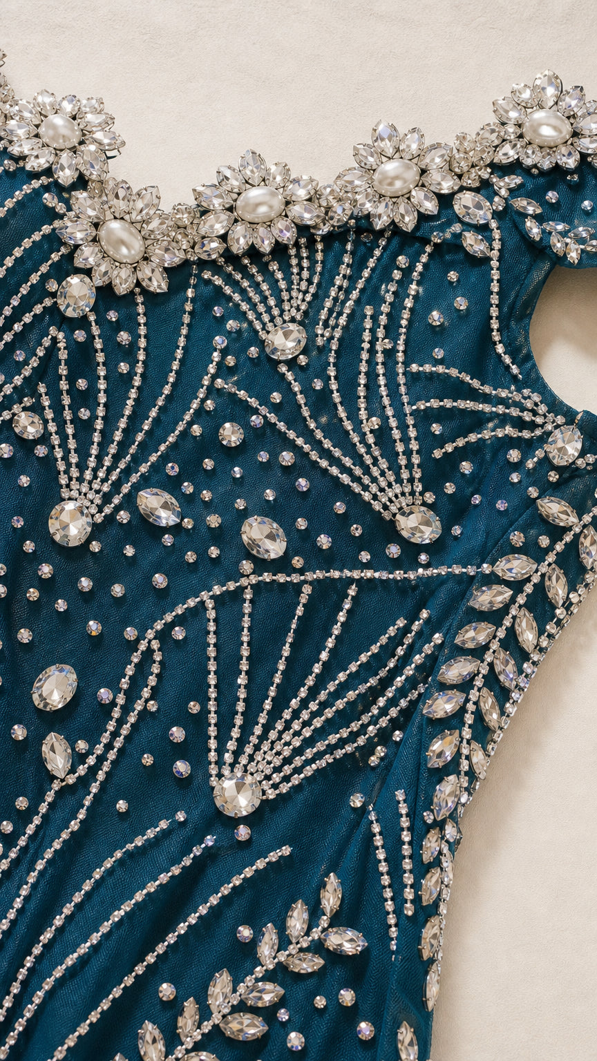 Close-up detail of pearl and rhinestone embellishments on the neckline