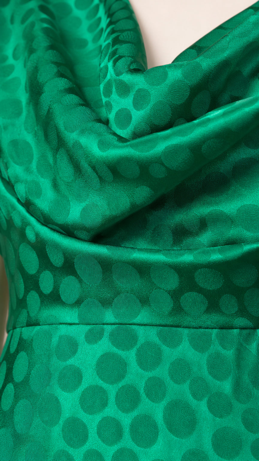 Close-up texture view of green satin fabric with tonal jacquard dots