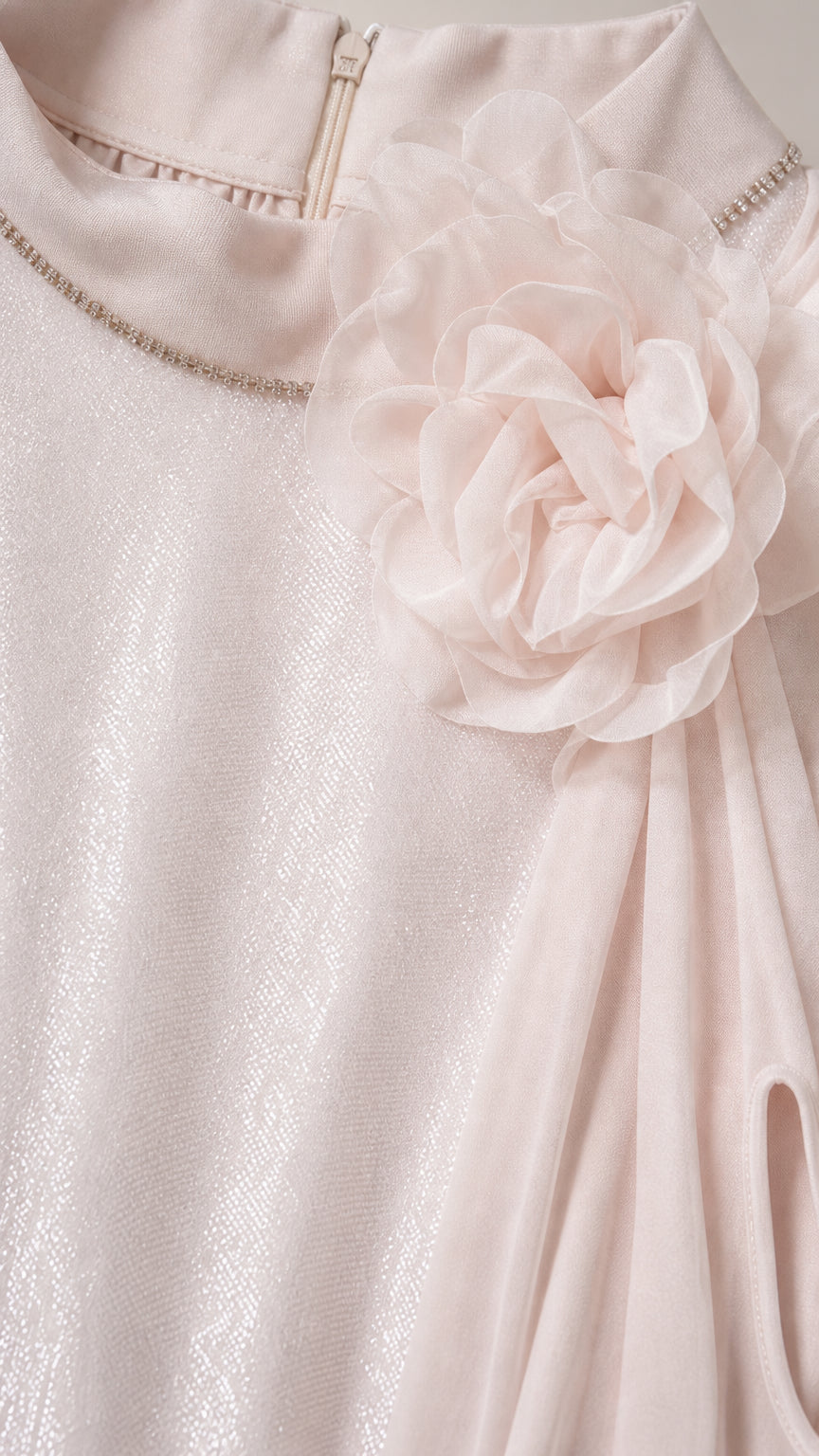 Close-up detail of the mock neckline, rhinestone trim, and 3D floral appliqué