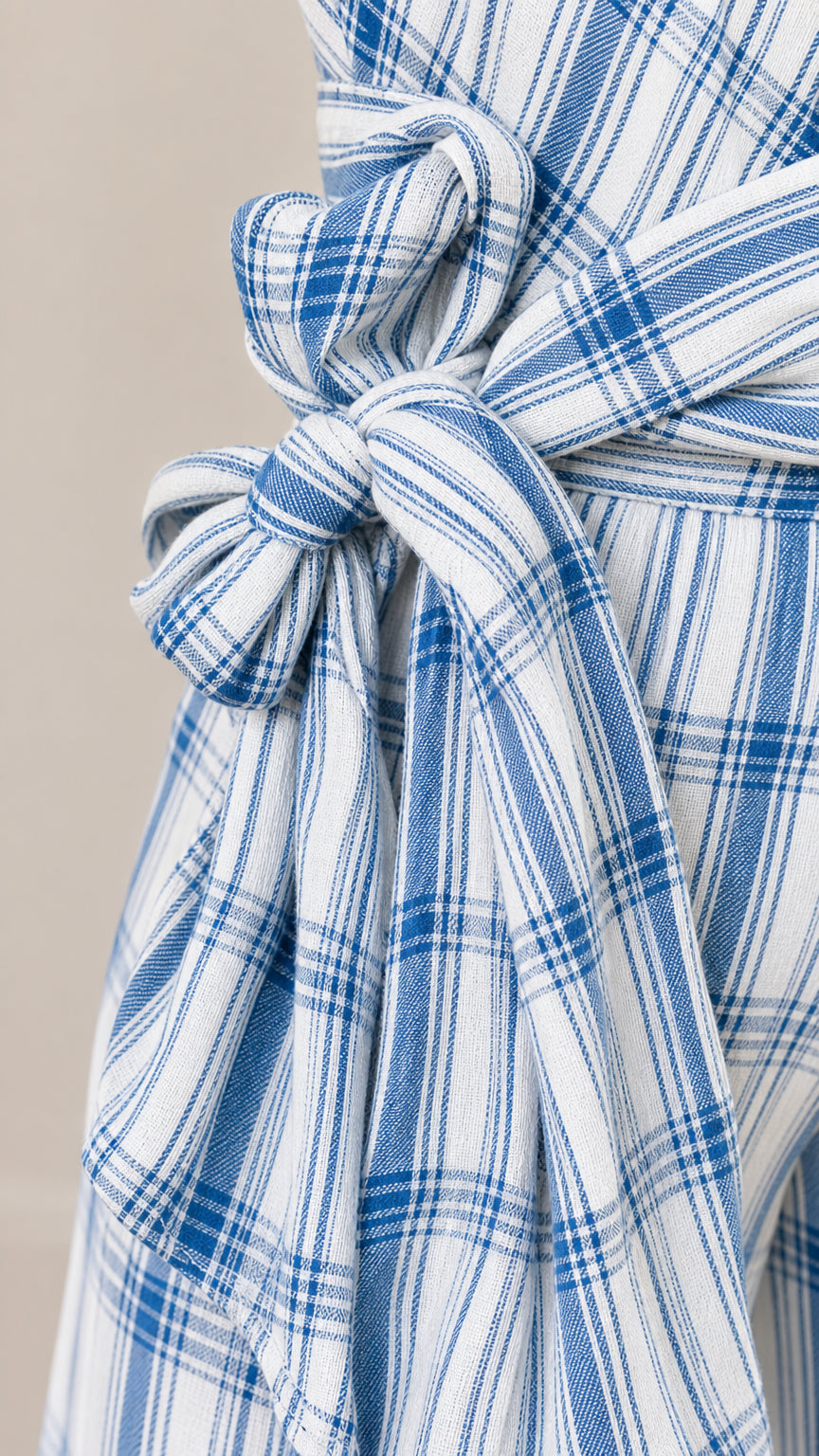 Close-up detail of the fabric texture and self-tie waist sash