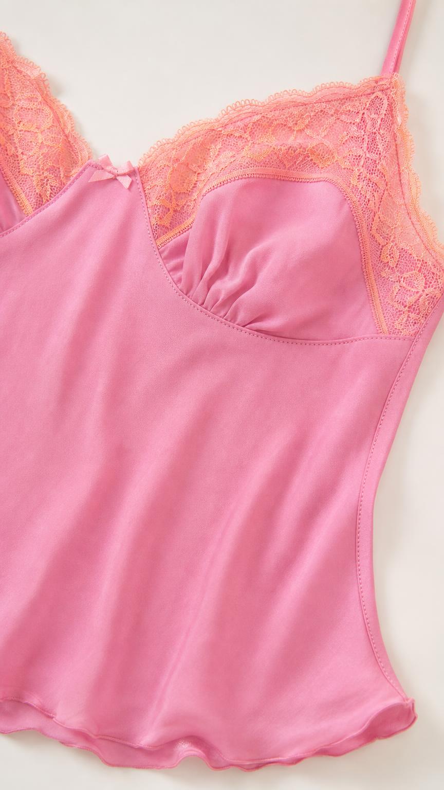 Close-up of pink camisole bodice with lace trim and bow