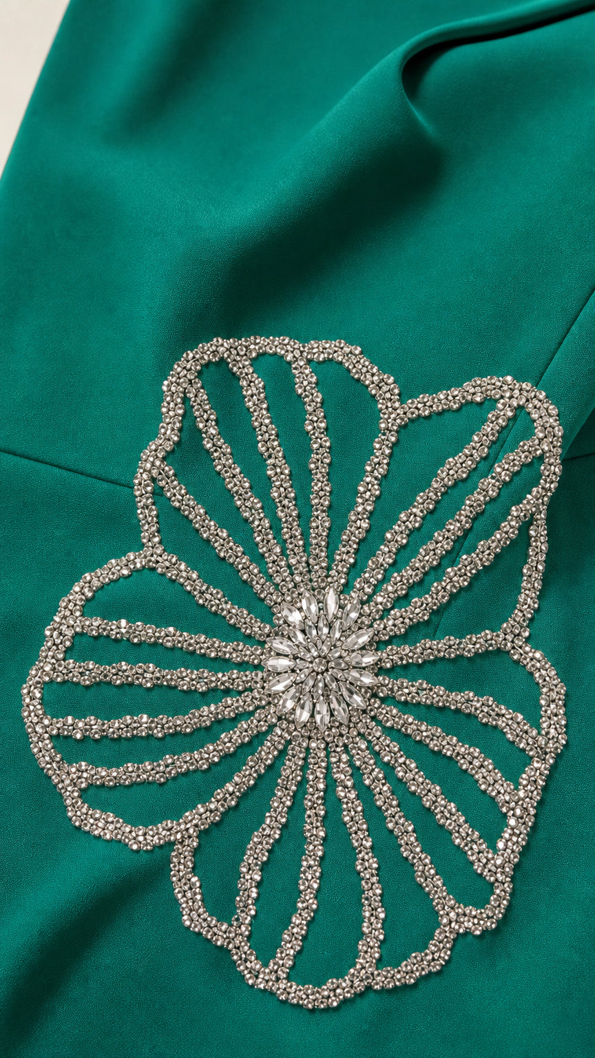 Close-up of intricate crystal beaded floral appliqué on fabric
