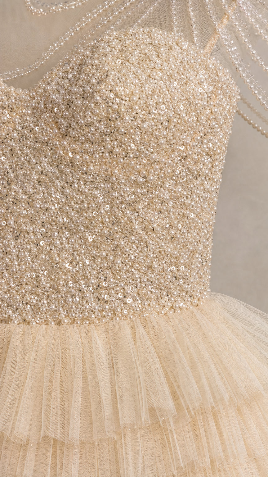 Close-up detail of sequined bodice and beaded sheer neckline
