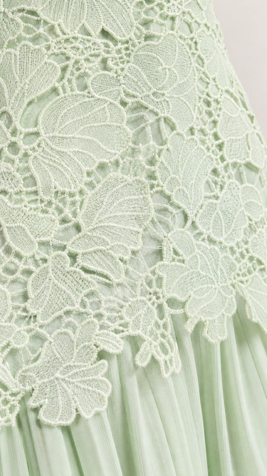 Close-up detail of floral lace applique and pleating on Sage Green dress