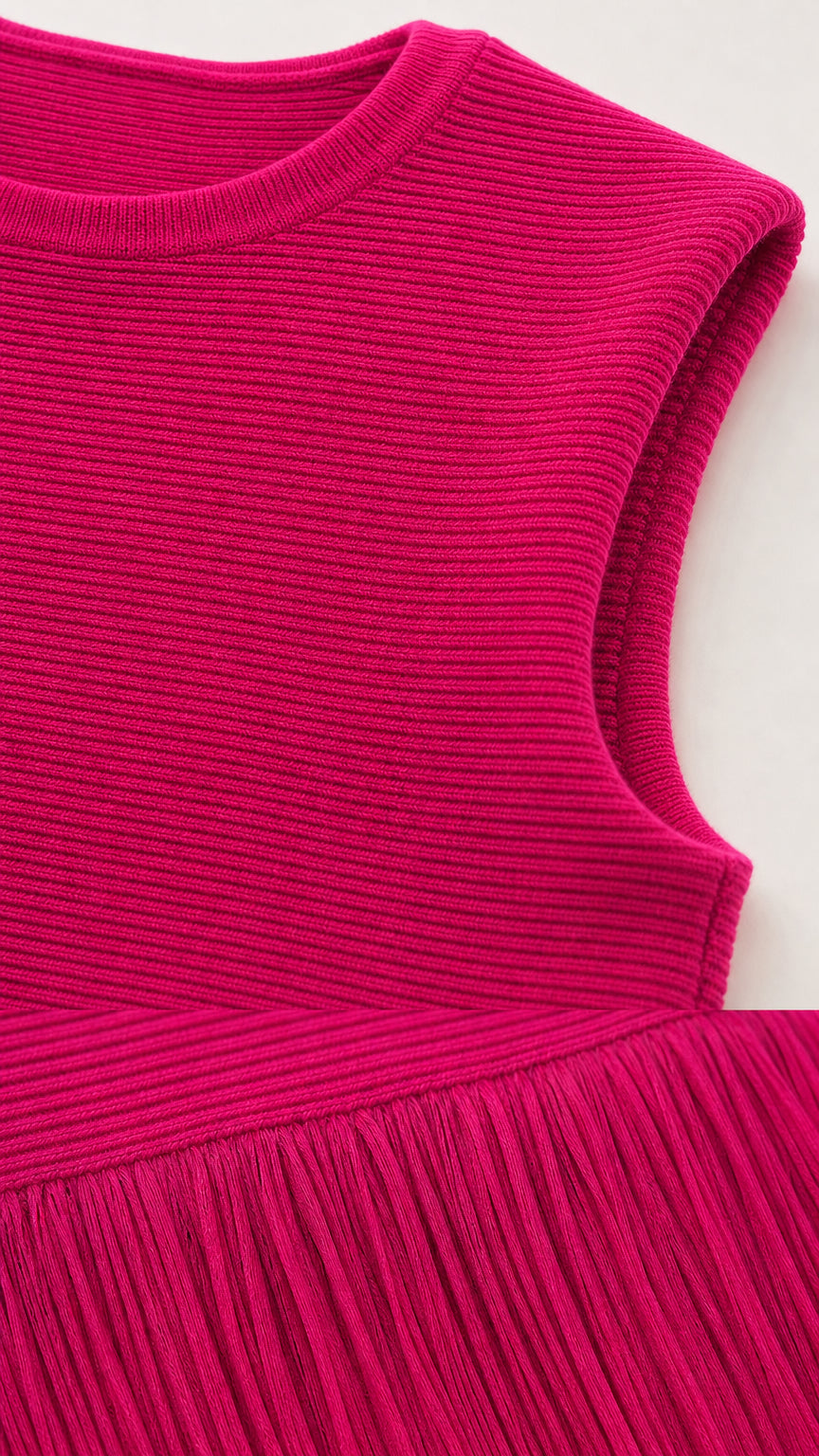 Close-up detail of round neckline, ribbed knit texture, and fringe transition