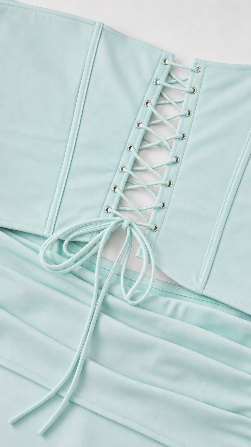 Close-up detail of lace-up corset back and smooth fabric