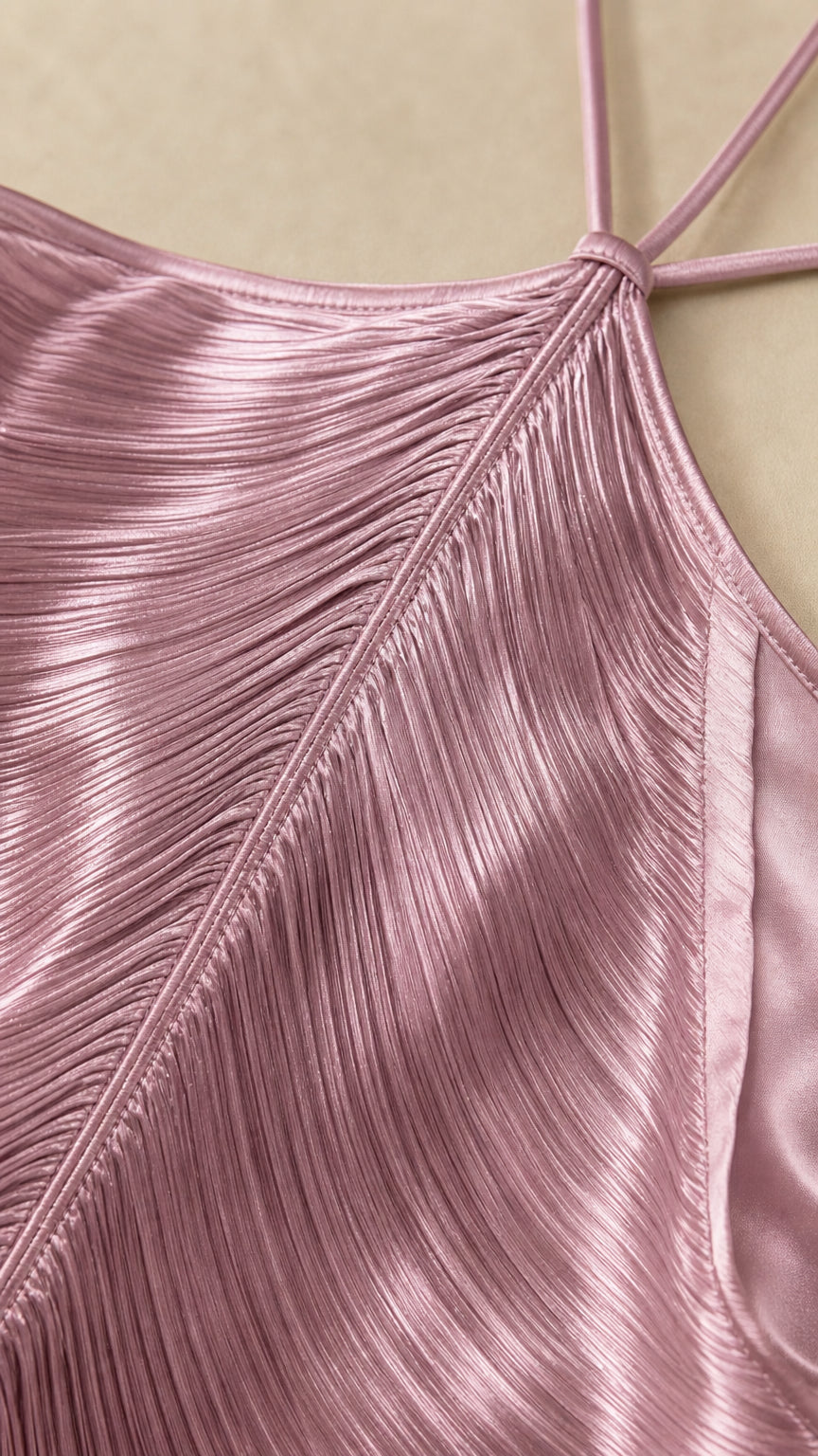 Close-up detail of halter neckline and micro-pleated fabric texture