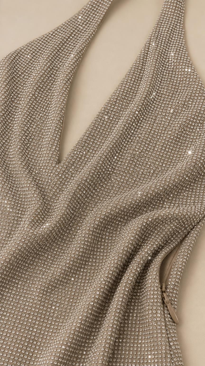 Close-up fabric texture detail of shimmering rhinestone halter dress