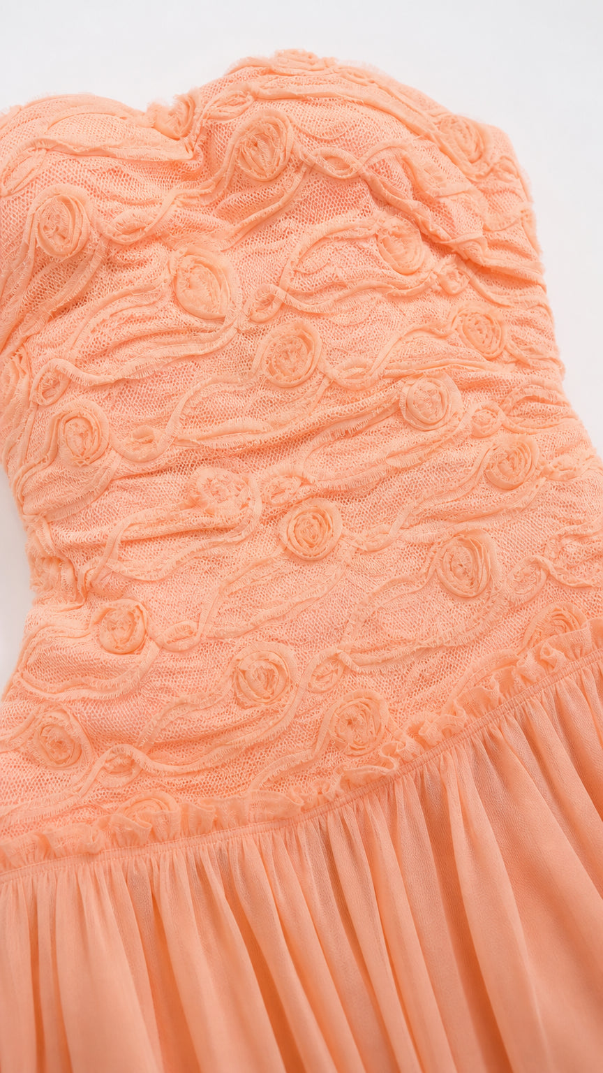 Close up of textured bodice on peach maxi dress