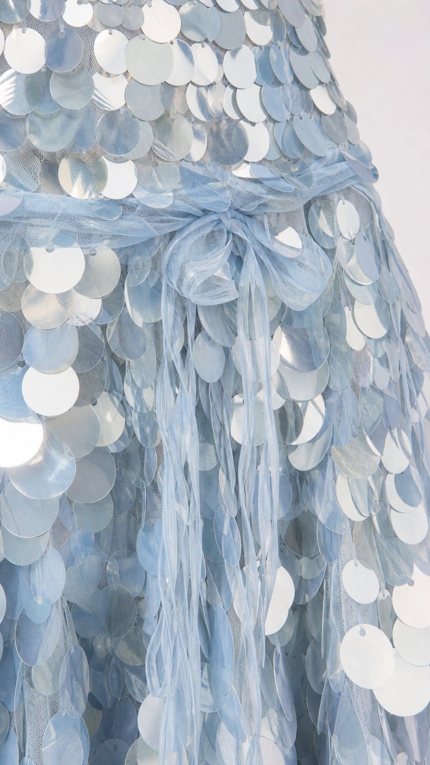 Close-up of the layered round sequin texture on the dress