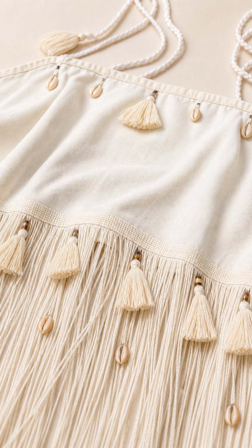 Close-up detail of tassel fringe and seashell embellishments