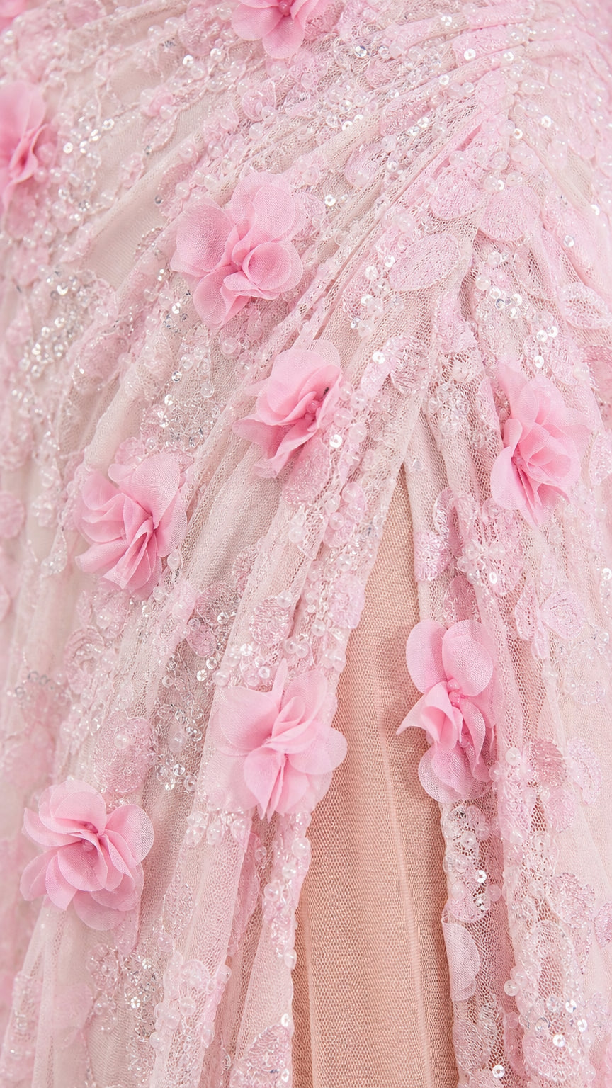 Close-up detail of pink 3D floral appliques and mesh fabric