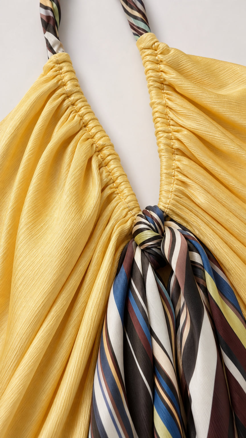 Close-up detail of halter neckline and knotted stripe scarf